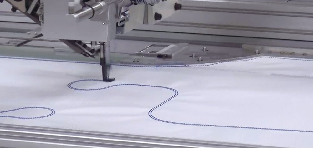Sewing system using a double-arm